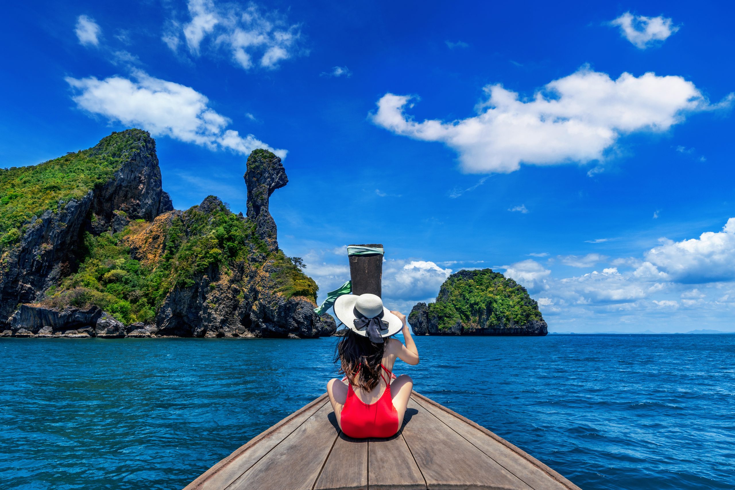 Beautiful girl in red bikini on boat at Koh Kai island, Thailand